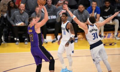 Los Angeles Lakers guard Luka Doncic (77) shoots over Dallas Mavericks guard Klay Thompson (31) during the second half of an NBA basketball game Tuesday, Feb. 25, 2025, in Los Angeles. (AP Photo/Kyusung Gong)