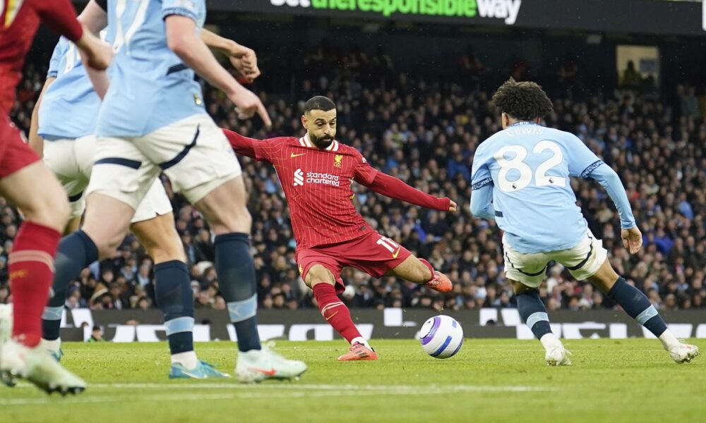 Liverpool's Mohamed Salah, center, scores his side's opening goal during the English Premier League soccer match between Manchester City and Liverpool at Etihad stadium in Manchester, England, Sunday, Feb. 23, 2025. (AP Photo/Dave Thompson)