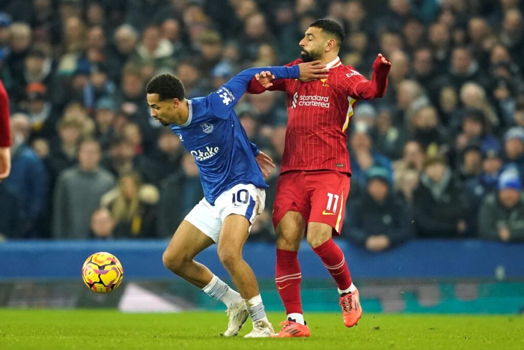 Liverpool's Mohamed Salah, right, challenges for the ball with Everton's Iliman Ndiaye during the English Premier League soccer match between Everton and Liverpool, Liverpool, England, Wednesday, Feb.12, 2025. (AP Photo/Dave Thompson)