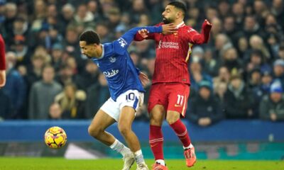 Liverpool's Mohamed Salah, right, challenges for the ball with Everton's Iliman Ndiaye during the English Premier League soccer match between Everton and Liverpool, Liverpool, England, Wednesday, Feb.12, 2025. (AP Photo/Dave Thompson)