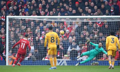 Liverpool's Mohamed Salah, left, shoots to score from the penalty spot during the English Premier League soccer match between Liverpool and Wolverhampton Wanderers at Anfield Stadium in Liverpool, Sunday, Feb. 16, 2025. (AP Photo/Ian Hodgson)