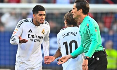 Real Madrid's Jude Bellingham, left, speaks with Real Madrid's Luka Modric after after being shown a red card by the referee during a Spanish La Liga soccer match between Osasuna and Real Madrid at El Sardar stadium in Pamplona, Spain, Saturday, Feb. 15, 2025. (AP Photo/Miguel Oses)