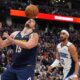 Denver Nuggets center Nikola Jokic, left, avoids the ball after dunking it for a basket as Orlando Magic guard Trevelin Queen looks on in the second half of an NBA basketball game Thursday, Feb. 6, 2025, in Denver. (AP Photo/David Zalubowski)