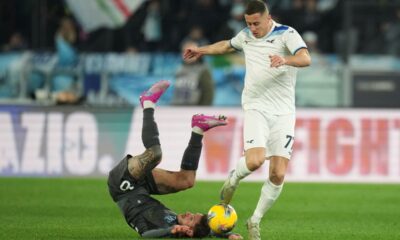 Napoli's Pasquale Mazzocchi, left, falls on the pitch challenged by Lazio's Adam Marusic during a Serie A soccer match between Lazio and Napoli in Rome, Italy, Saturday, Feb. 15, 2025. (AP Photo/Andrew Medichini)