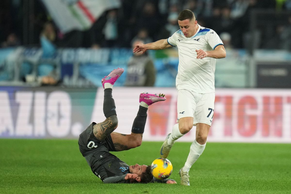 Napoli's Pasquale Mazzocchi, left, falls on the pitch challenged by Lazio's Adam Marusic during a Serie A soccer match between Lazio and Napoli in Rome, Italy, Saturday, Feb. 15, 2025. (AP Photo/Andrew Medichini)