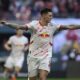 Leipzig's Benjamin Sesko celebrates after scoring his side's second goal during the German Bundesliga soccer match between RB Leipzig and 1. FC Heidenheim in Leipzig, Germany, Sunday, Feb. 23, 2025. (Hendrik Schmidt/dpa via AP)