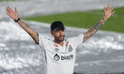 Brazilian soccer player Neymar waves to fans during his presentation ceremony after signing a six-month contract with Santos FC at Vila Belmiro Stadium in Santos, Brazil, Friday, Jan. 31, 2025. (AP Photo/Andre Penner)