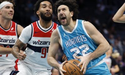 Charlotte Hornets guard Vasilije Micic (22) drives to the basket against Washington Wizards forward Justin Champagnie (9) during the first half of an NBA basketball game in Charlotte, N.C., Monday, Feb. 3, 2025. (AP Photo/Nell Redmond)