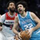 Charlotte Hornets guard Vasilije Micic (22) drives to the basket against Washington Wizards forward Justin Champagnie (9) during the first half of an NBA basketball game in Charlotte, N.C., Monday, Feb. 3, 2025. (AP Photo/Nell Redmond)