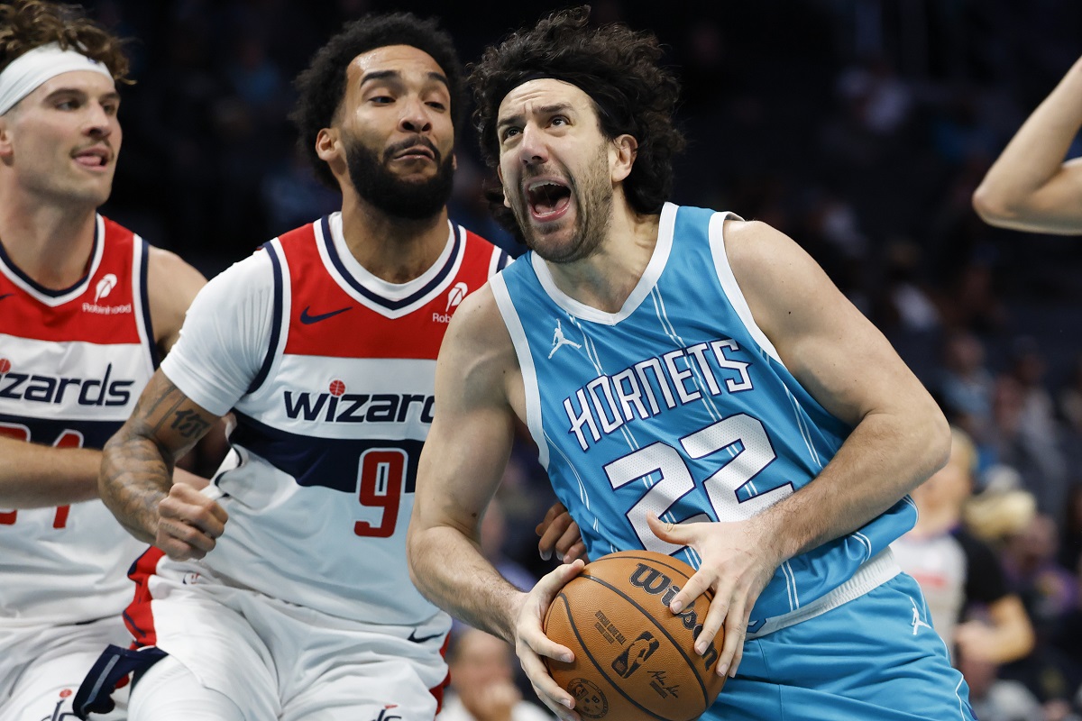 Charlotte Hornets guard Vasilije Micic (22) drives to the basket against Washington Wizards forward Justin Champagnie (9) during the first half of an NBA basketball game in Charlotte, N.C., Monday, Feb. 3, 2025. (AP Photo/Nell Redmond)