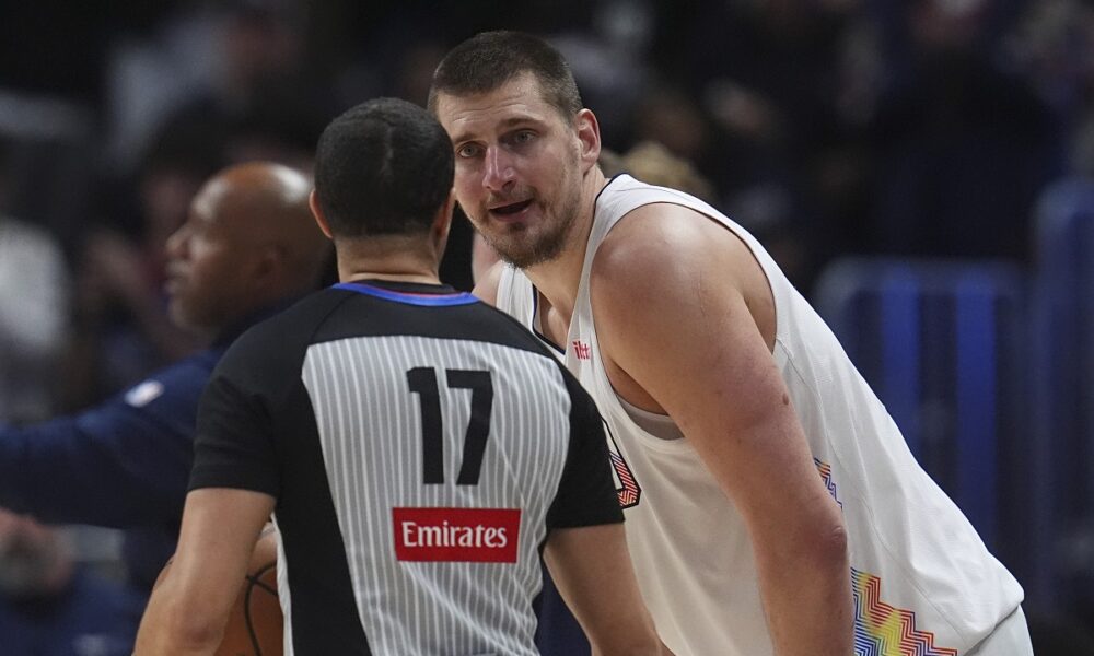 Denver Nuggets center Nikola Jokic, back, argues for a call with referee Jonathan Sterling in the second half of an NBA basketball game against the New Orleans Pelicans Wednesday, Feb. 5, 2025, in Denver. (AP Photo/David Zalubowski)