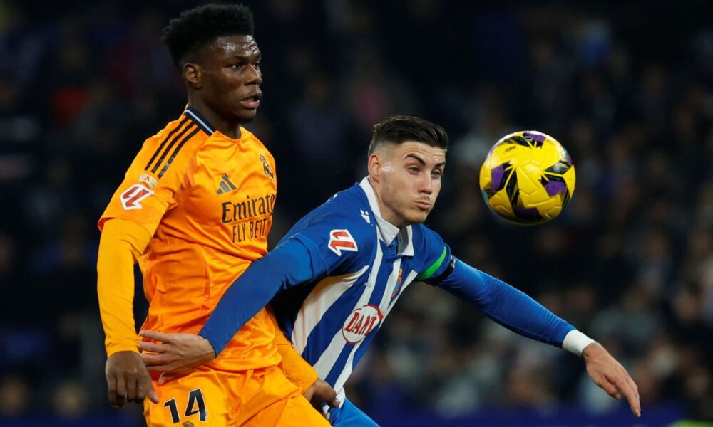 Real Madrid's Aurelien Tchouameni, left, challenges for the ball with Espanyol's Roberto Fernandez during a Spanish La Liga soccer match between Espanyol and Real Madrid at the Lluis Companys Olympic Stadium in Barcelona, Spain, Saturday Feb.1, 2025. (AP Photo/Joan Monfort)