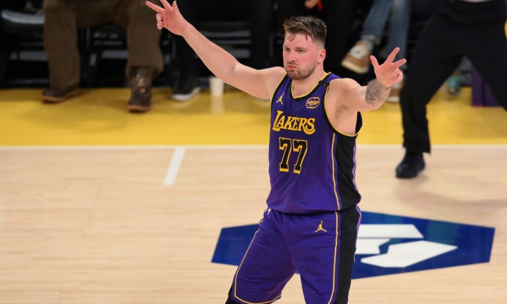 Los Angeles Lakers guard Luka Doncic reacts after Austin Reaves' 3-point basket during the first half of an NBA basketball game against the Dallas Mavericks, Tuesday, Feb. 25, 2025, in Los Angeles. (AP Photo/Kyusung Gong)