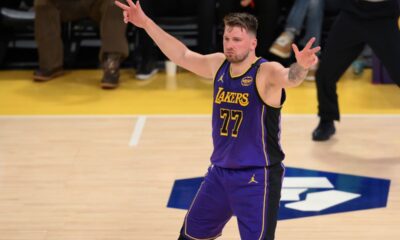 Los Angeles Lakers guard Luka Doncic reacts after Austin Reaves' 3-point basket during the first half of an NBA basketball game against the Dallas Mavericks, Tuesday, Feb. 25, 2025, in Los Angeles. (AP Photo/Kyusung Gong)