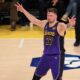 Los Angeles Lakers guard Luka Doncic reacts after Austin Reaves' 3-point basket during the first half of an NBA basketball game against the Dallas Mavericks, Tuesday, Feb. 25, 2025, in Los Angeles. (AP Photo/Kyusung Gong)