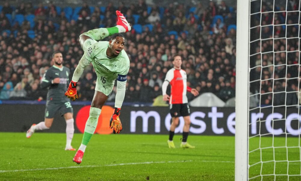 AC Milan's goalkeeper Mike Maignan dives to save a shot during the Champions League playoff first leg soccer match between Feyenoord and AC Milan, at the De Kuip stadium, in Rotterdam, Netherlands, Wednesday, Feb. 12, 2025. (AP Photo/Peter Dejong)