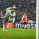 AC Milan's goalkeeper Mike Maignan dives to save a shot during the Champions League playoff first leg soccer match between Feyenoord and AC Milan, at the De Kuip stadium, in Rotterdam, Netherlands, Wednesday, Feb. 12, 2025. (AP Photo/Peter Dejong)