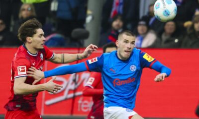 Bochum's Moritz Broschinski, left, and Kiel's David Zec in action during the Bundesliga soccer match between Holstein Kiel - VfL Bochum at the Holstein-Stadion, Kiel, Germany, Sunday Feb. 9, 2025. (Frank Molter/dpa via AP)