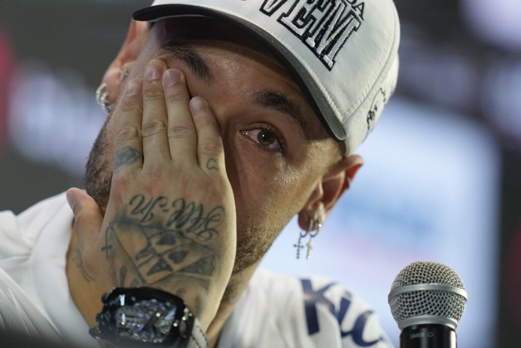 Brazilian soccer player Neymar wipes his eye during a news conference after signing a six-month contract with Santos FC at Vila Belmiro Stadium in Santos, Brazil, Friday, Jan. 31, 2025. (AP Photo/Andre Penner)