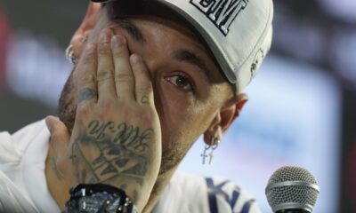 Brazilian soccer player Neymar wipes his eye during a news conference after signing a six-month contract with Santos FC at Vila Belmiro Stadium in Santos, Brazil, Friday, Jan. 31, 2025. (AP Photo/Andre Penner)