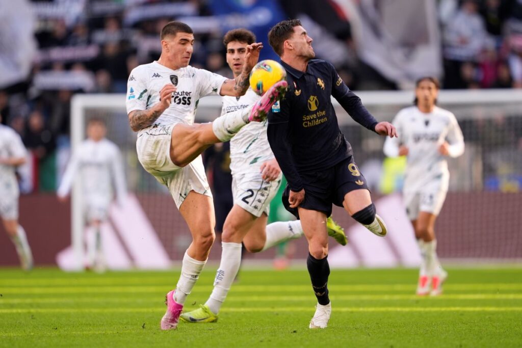 Empoli's Luca Marianucci, left, fights for the ball with Dušan Vlahović during the Serie A soccer match between Juventus and Empoli at the Juventus Stadium in Turin, Italy, Sunday, Feb. 2, 2024. (Fabio Ferrari/LaPresse via AP)