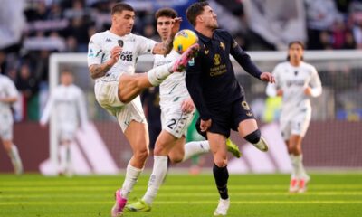 Empoli's Luca Marianucci, left, fights for the ball with Dušan Vlahović during the Serie A soccer match between Juventus and Empoli at the Juventus Stadium in Turin, Italy, Sunday, Feb. 2, 2024. (Fabio Ferrari/LaPresse via AP)