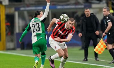 AC Milan's Strahinja Pavlovic, right, challenges for the ball with Feyenoord's Anis Hadj Moussa during Champions League, playoff second leg soccer match between AC Milan and Feyenoord, at the San Siro stadium in Milan, Italy, Tuesday, Feb.18, 2025. (AP Photo/Luca Bruno)