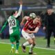 AC Milan's Strahinja Pavlovic, right, challenges for the ball with Feyenoord's Anis Hadj Moussa during Champions League, playoff second leg soccer match between AC Milan and Feyenoord, at the San Siro stadium in Milan, Italy, Tuesday, Feb.18, 2025. (AP Photo/Luca Bruno)