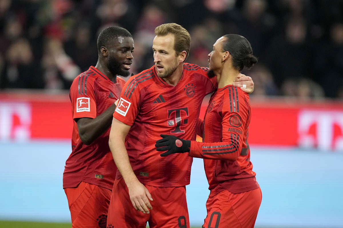 Bayern's Leroy Sane, right, is congratulated by Bayern's Harry Kane, center, after scoring his sides second goal during the German Bundesliga soccer match between Bayern Munich and Werder Bremen at the Allianz Arena in Munich, Germany, Friday, Feb. 7, 2025. (AP Photo/Matthias Schrader)