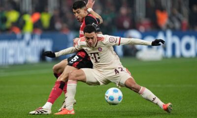 Bayern's Jamal Musiala, right, challenges for the ball with Leverkusen's Exequiel Palacios during the German Bundesliga soccer match between Bayer Leverkusen and FC Bayern Munich at the BayArena in Leverkusen, Germany, Saturday, Feb. 15, 2025. (AP Photo/Martin Meissner)