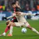 Bayern's Jamal Musiala, right, challenges for the ball with Leverkusen's Exequiel Palacios during the German Bundesliga soccer match between Bayer Leverkusen and FC Bayern Munich at the BayArena in Leverkusen, Germany, Saturday, Feb. 15, 2025. (AP Photo/Martin Meissner)