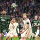 Celtic's Cameron Carter-Vickers, left, Bayern's Harry Kane, centre, Celtic's Alistair Johnston, right, in action during the Champions League playoff second leg soccer match between FC Bayern Munich and Celtic Glasgow at the Allianz Arena in Munich, Germany, Tuesday, Feb. 18, 2025. (AP Photo/Matthias Schrader)