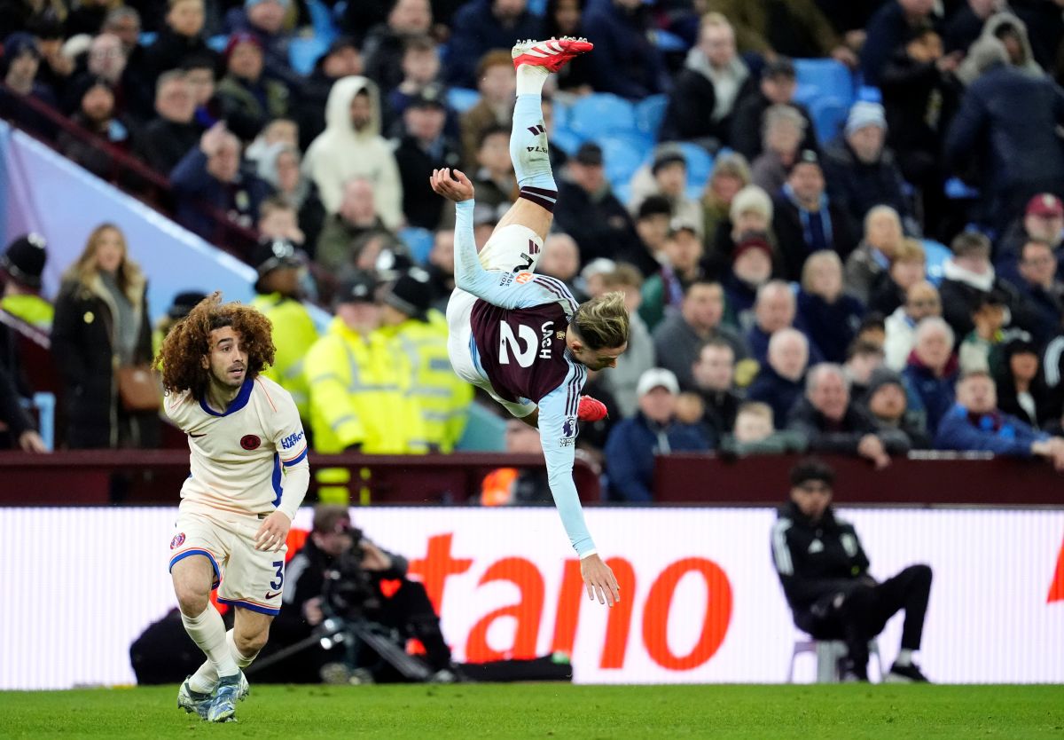 Aston Villa's Matty Cash hits the floor during their English Premier League soccer match against Chelsea at Villa Park, Birmingham, England, Saturday, Feb. 22, 2025. (Nick Potts/PA via AP)