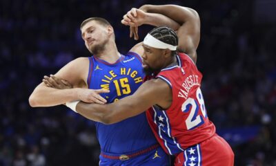 Denver Nuggets' Nikola Jokic, left, and Philadelphia 76ers' Guerschon Yabusele wrestle for position during the first half of an NBA basketball game, Friday, Jan. 31, 2025, in Philadelphia. (AP Photo/Matt Slocum)