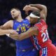 Denver Nuggets' Nikola Jokic, left, and Philadelphia 76ers' Guerschon Yabusele wrestle for position during the first half of an NBA basketball game, Friday, Jan. 31, 2025, in Philadelphia. (AP Photo/Matt Slocum)