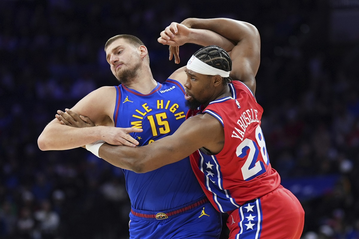 Denver Nuggets' Nikola Jokic, left, and Philadelphia 76ers' Guerschon Yabusele wrestle for position during the first half of an NBA basketball game, Friday, Jan. 31, 2025, in Philadelphia. (AP Photo/Matt Slocum)