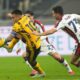 Inter Milan's Lautaro Martinez, left, challenges for the ball with Genoa's Patrizio Masini during a Serie A soccer match between Inter Milan and Genoa, at the San Siro stadium in Milan, Italy, Saturday, Feb. 22, 2025. (AP Photo/Luca Bruno)