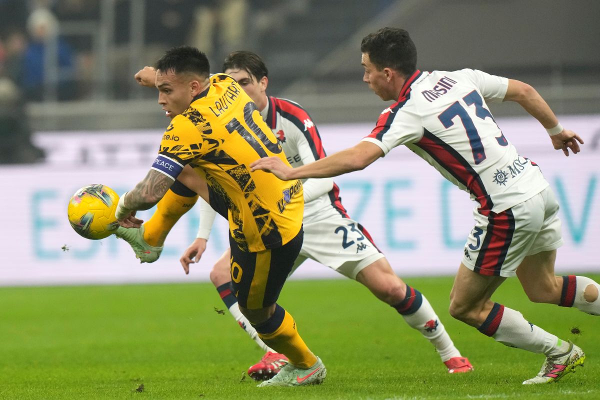 Inter Milan's Lautaro Martinez, left, challenges for the ball with Genoa's Patrizio Masini during a Serie A soccer match between Inter Milan and Genoa, at the San Siro stadium in Milan, Italy, Saturday, Feb. 22, 2025. (AP Photo/Luca Bruno)