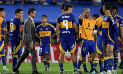 Coach Fernando Gago of Argentina's Boca Juniors, left, and his players react after losing a penalty shootout against Peru's Alianza Lima during a Copa Libertadores soccer match at La Bombonera stadium in Buenos Aires, Argentina, Tuesday, Feb. 25, 2025. (AP Photo/Gustavo Garello)