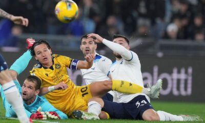 Udinese's Florian Thauvin, centre left, challenges for the ball during the Serie A soccer match between Lazio and Udinese at the Rome's Olympic stadium, Italy, Monday, March 10, 2025. (Alfredo Falcone/LaPresse via AP)