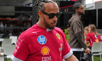 Ferrari driver Lewis Hamilton of Britain walks through the paddock ahead of the Australian Formula One Grand Prix at Albert Park, in Melbourne, Australia, Thursday, March 13, 2025. (AP Photo/Heath McKinley )