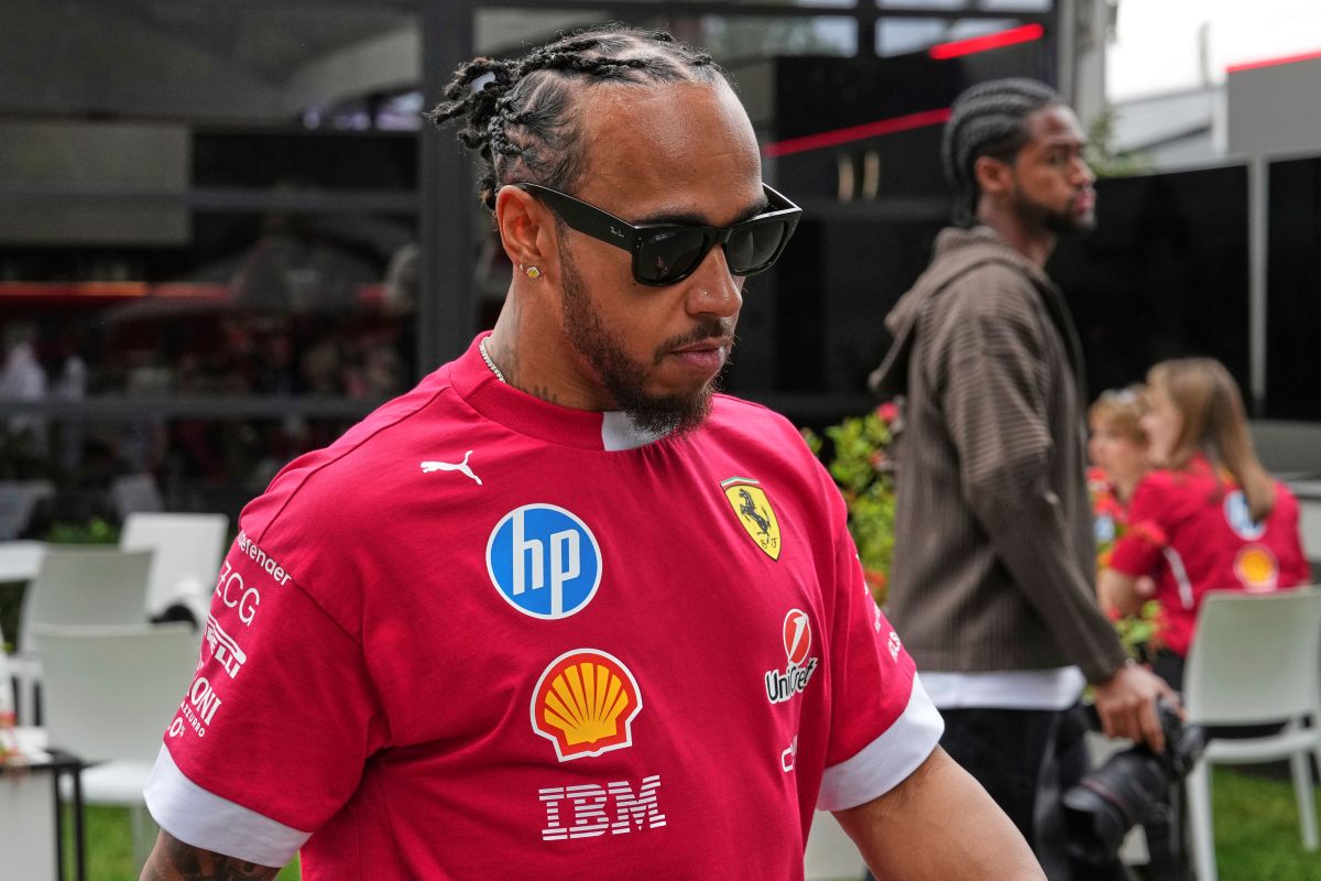 Ferrari driver Lewis Hamilton of Britain walks through the paddock ahead of the Australian Formula One Grand Prix at Albert Park, in Melbourne, Australia, Thursday, March 13, 2025. (AP Photo/Heath McKinley )