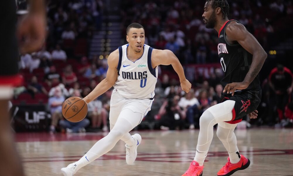 Dallas Mavericks guard Dante Exum (0) controls the ball against Houston Rockets forward Tari Eason (17) during the first half of an NBA basketball game in Houston, Friday, March 14, 2025. (AP Photo/Ashley Landis)