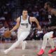 Dallas Mavericks guard Dante Exum (0) controls the ball against Houston Rockets forward Tari Eason (17) during the first half of an NBA basketball game in Houston, Friday, March 14, 2025. (AP Photo/Ashley Landis)