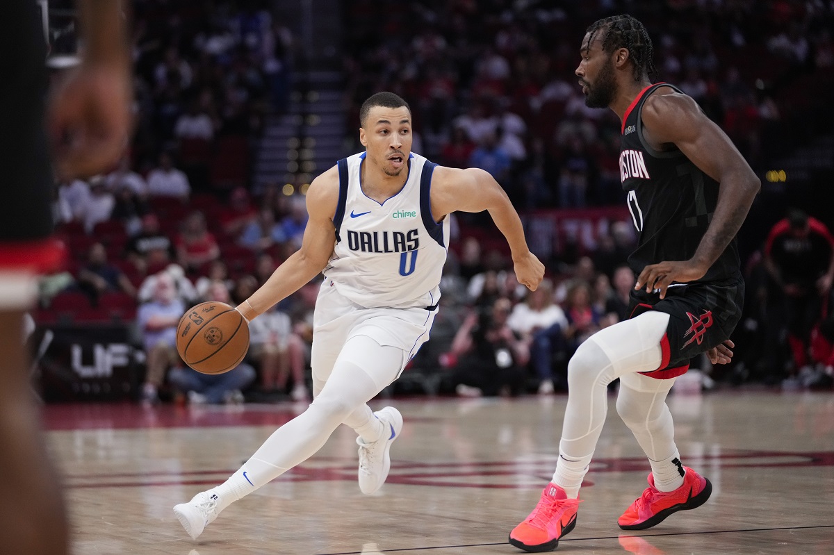 Dallas Mavericks guard Dante Exum (0) controls the ball against Houston Rockets forward Tari Eason (17) during the first half of an NBA basketball game in Houston, Friday, March 14, 2025. (AP Photo/Ashley Landis)