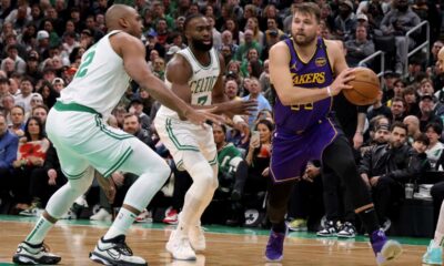 Los Angeles Lakers guard Luka Doncic, right, manoeuvres around Boston Celtics center Al Horford, left, and Boston Celtics guard Jaylen Brown, right, during the first half of an NBA basketball game, Saturday, March 8, 2025, in Boston. (AP Photo/Mark Stockwell)