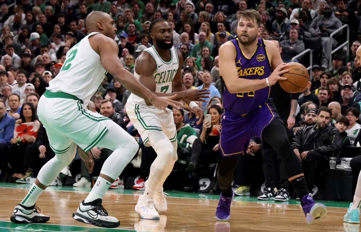 Los Angeles Lakers guard Luka Doncic, right, manoeuvres around Boston Celtics center Al Horford, left, and Boston Celtics guard Jaylen Brown, right, during the first half of an NBA basketball game, Saturday, March 8, 2025, in Boston. (AP Photo/Mark Stockwell)