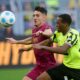 Dortmund's Jamie Gittens, right, and Augsburg's Dimitris Giannoulis in action during the German Bundesliga soccer match between Borussia Dortmund and FC Augsburg at the Signal Iduna Park in Dortmund, Germany, Saturday, March 8, 2025. (Bernd Thissen/dpa via AP)