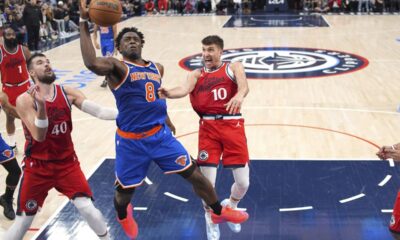 New York Knicks forward OG Anunoby, center, shoots as Los Angeles Clippers center Ivica Zubac, left, and guard Bogdan Bogdanovic defend during the second half of an NBA basketball game Friday, March 7, 2025, in Inglewood, Calif. (AP Photo/Mark J. Terrill)