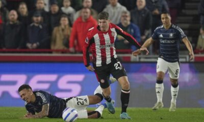 Aston Villa's Morgan Rogers falls following a challenge from Brentford's Vitaly Janelt during the English Premier League soccer match between Brentford and Aston Villa at the Gtech Community stadium in London, Saturday, March 8, 2025. (AP Photo/Kin Cheung)